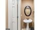 Cozy powder room with pedestal sink, decorative mirror, and neutral paint at 1198 Elliot Rd, Mcdonough, GA 30252