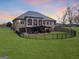 Expansive brick home featuring an outdoor living area and a fenced-in backyard with well-maintained green lawn at 1198 Elliot Rd, Mcdonough, GA 30252
