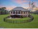 Expansive brick home featuring an outdoor living area and a fenced-in backyard with well-maintained green lawn at 1198 Elliot Rd, Mcdonough, GA 30252