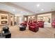 Home theater room featuring red reclining chairs, adjacent bar, game room, and theater-style popcorn machine at 1198 Elliot Rd, Mcdonough, GA 30252