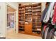 Walk-in closet with custom shelving for shoes, a built-in dresser, and hanging racks at 1198 Elliot Rd, Mcdonough, GA 30252