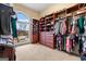Walk-in closet featuring custom wooden organizers, drawers, and shelving with a large window at 1198 Elliot Rd, Mcdonough, GA 30252