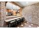 Wet bar area featuring a brick wall, barstool seating and views to the kitchen and stainless steel appliances at 1198 Elliot Rd, Mcdonough, GA 30252