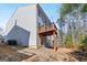 Backyard view featuring a wooden deck, house siding, and surrounding trees, showcasing outdoor space at 88 Hardy Water Dr, Lawrenceville, GA 30045