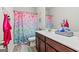 Bathroom featuring colorful mermaid-themed shower curtain, vanity, and tile, ideal for a bathroom at 88 Hardy Water Dr, Lawrenceville, GA 30045