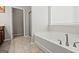 This bathroom features a large soaking tub and tile flooring at 88 Hardy Water Dr, Lawrenceville, GA 30045