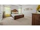 Spacious bedroom with a light wood bed frame, large windows, and wall decor, creating a tranquil atmosphere at 88 Hardy Water Dr, Lawrenceville, GA 30045