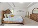 Bedroom featuring a wooden bed frame, dresser, and ample space, with light tones and decorative wall art at 88 Hardy Water Dr, Lawrenceville, GA 30045