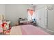 Cozy bedroom with a pink bedspread, desk, and decorative items, designed as a charming space at 88 Hardy Water Dr, Lawrenceville, GA 30045