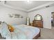 Spacious bedroom featuring patterned bedding, a wooden dresser, and ample natural light, offering comfort and style at 88 Hardy Water Dr, Lawrenceville, GA 30045