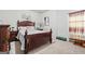Bedroom with dark wooden furniture, neutral carpet, and decor, providing a comfortable and stylish space at 88 Hardy Water Dr, Lawrenceville, GA 30045