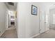 Well-lit hallway with neutral paint and carpet, leading to various rooms in the home at 88 Hardy Water Dr, Lawrenceville, GA 30045