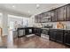 This kitchen offers dark cabinetry, stainless steel appliances, granite countertops, and hardwood floors at 88 Hardy Water Dr, Lawrenceville, GA 30045