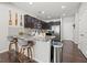 Bright eat-in kitchen features granite countertops, stainless steel appliances, and stylish pendant lighting at 88 Hardy Water Dr, Lawrenceville, GA 30045