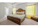 This bedroom features a wooden bed frame and bright, sunny yellow curtains at 88 Hardy Water Dr, Lawrenceville, GA 30045