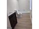 Bright bathroom featuring a modern vanity and new fixtures, tub, and tile at 138 Plantation Cir, Clarkston, GA 30021