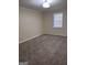 Spacious bedroom with carpet flooring and a bright window providing natural light at 138 Plantation Cir, Clarkston, GA 30021