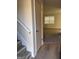 Inviting entryway features wood floors, staircase with white railing, and view into a carpeted living space at 138 Plantation Cir, Clarkston, GA 30021
