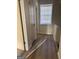 Bright hallway featuring wood floors, and a window providing natural light at 138 Plantation Cir, Clarkston, GA 30021