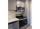 Modern kitchen featuring stainless steel appliances, gray cabinets, and updated countertops at 138 Plantation Cir, Clarkston, GA 30021