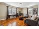 Cozy living room featuring hardwood floors, multiple windows, and comfortable furniture at 2114 Fellowship Rd, Tucker, GA 30084