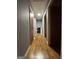 View of hallway with hardwood floors, neutral walls, and multiple doorways at 975 King James Dr, Morrow, GA 30260