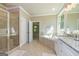 Luxurious bathroom features a soaking tub, double vanity with granite countertop, and walk-in shower at 204 Shelton Dr, Mcdonough, GA 30252