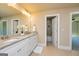 Bathroom features double sink vanity with granite counters and tiled floor at 204 Shelton Dr, Mcdonough, GA 30252