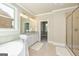 Luxurious bathroom featuring a soaking tub, double vanity with granite countertop, and walk-in shower at 204 Shelton Dr, Mcdonough, GA 30252