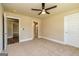 Spacious bedroom featuring plush carpet, a ceiling fan, and ample natural light at 204 Shelton Dr, Mcdonough, GA 30252