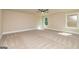 A spacious bedroom with natural light and neutral carpeting at 204 Shelton Dr, Mcdonough, GA 30252