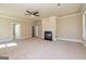 Spacious bonus room with a fireplace, neutral walls, plush carpeting, and ceiling fan at 204 Shelton Dr, Mcdonough, GA 30252