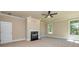 Bonus room features a cozy fireplace with white mantel, neutral walls, plush carpeting, and a ceiling fan at 204 Shelton Dr, Mcdonough, GA 30252