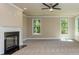 Bonus room with fireplace, neutral walls, plush carpeting, and an abundance of natural light at 204 Shelton Dr, Mcdonough, GA 30252