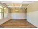 Empty dining room showcasing wood floors, wainscoting, box ceiling, and a large window at 204 Shelton Dr, Mcdonough, GA 30252