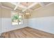 Dining room featuring wood floors, wainscoting, box ceiling, and a large window at 204 Shelton Dr, Mcdonough, GA 30252