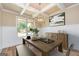 Dining area with a decorative light fixture, modern decor, and natural light from the large window at 204 Shelton Dr, Mcdonough, GA 30252