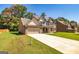 Two-story brick home with attached two-car garage, long driveway and landscaped lawn at 204 Shelton Dr, Mcdonough, GA 30252