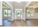 Bright foyer with wood floors, white trim, a front door with sidelights, and view to the yard at 204 Shelton Dr, Mcdonough, GA 30252