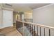 Hallway with wood floors and wrought iron stair railing at 204 Shelton Dr, Mcdonough, GA 30252
