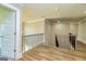 Hallway featuring hardwood floors and wood railing at 204 Shelton Dr, Mcdonough, GA 30252