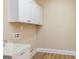 Laundry room with overhead cabinets and utility sink at 204 Shelton Dr, Mcdonough, GA 30252
