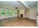 Open living area featuring hardwood floors, fireplace, and plenty of natural light at 204 Shelton Dr, Mcdonough, GA 30252