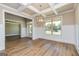 Living room view with wood floors, large windows, wainscoting, and box ceiling at 204 Shelton Dr, Mcdonough, GA 30252
