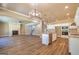 Open concept living area with hardwood floors, fireplace, and modern lighting at 204 Shelton Dr, Mcdonough, GA 30252