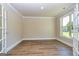 Open room with hardwood flooring, crown molding, and natural light at 204 Shelton Dr, Mcdonough, GA 30252