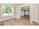 Bright room featuring hardwood floors, large windows, and ample natural light at 204 Shelton Dr, Mcdonough, GA 30252