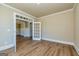 Light-filled room with hardwood flooring, large windows, and white trim at 204 Shelton Dr, Mcdonough, GA 30252