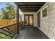 The back porch has black decking, interesting railings, and a surveillance camera above the back door at 1471 Hardin Ave, College Park, GA 30337