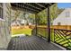Inviting covered back porch with stylish lattice railing offering serene views of the landscaped backyard at 1471 Hardin Ave, College Park, GA 30337